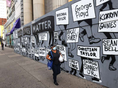 A woman walks past a Black Lives Matter mural on August 25, 2020 in New York City.