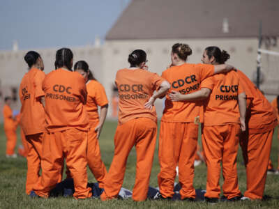 Inmates stand together in a yard at Central California Women's Facility