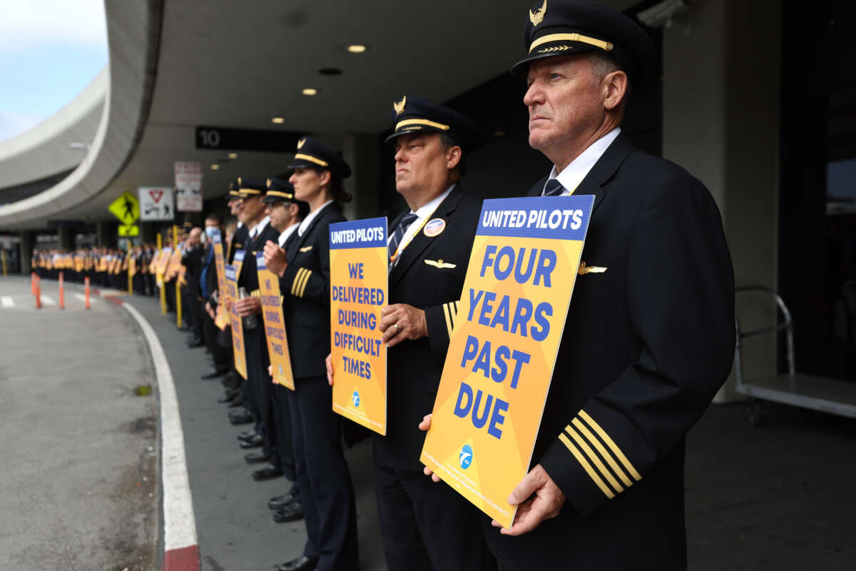 United Airlines pilots hold signs in front of the United Airlines terminal at San Francisco International Airport on May 12, 2023 in San Francisco, California.