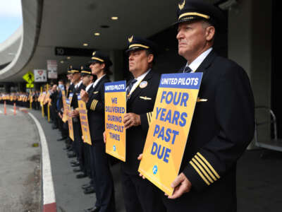 United Airlines pilots hold signs in front of the United Airlines terminal at San Francisco International Airport on May 12, 2023 in San Francisco, California.