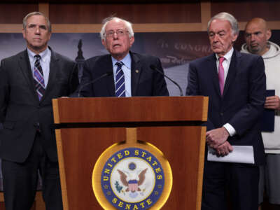 Sen. Bernie Sanders speaks as Sen. Jeff Merkley (left), Sen. Ed Markey and Sen. John Fetterman listen during a news conference on debt limit at the Capitol on May 18, 2023 in Washington, D.C.