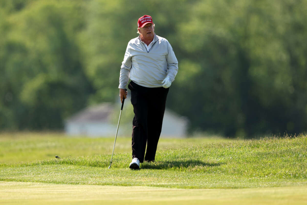 Former President Donald Trump follows his second shot during the pro-am prior to the LIV Golf Invitational - DC at Trump National Golf Club on May 25, 2023, in Sterling, Virginia.