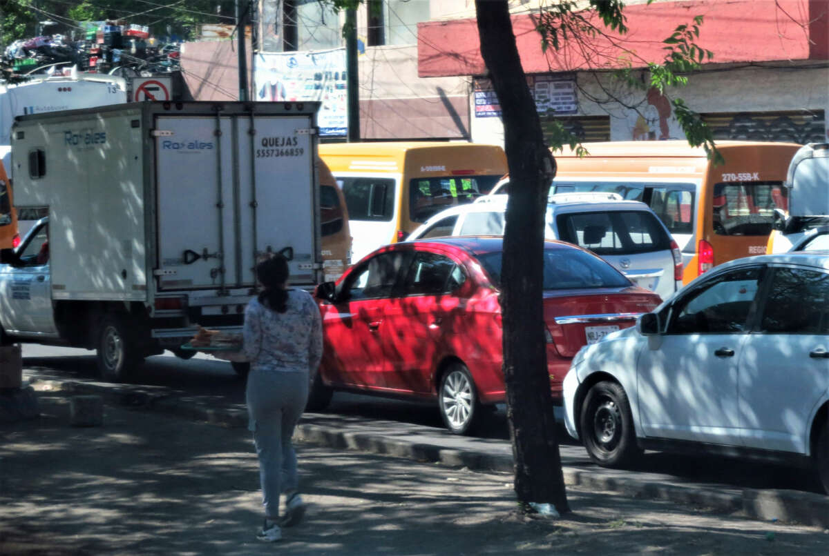 A person sells churros to slow-moving traffic in Mexico City.