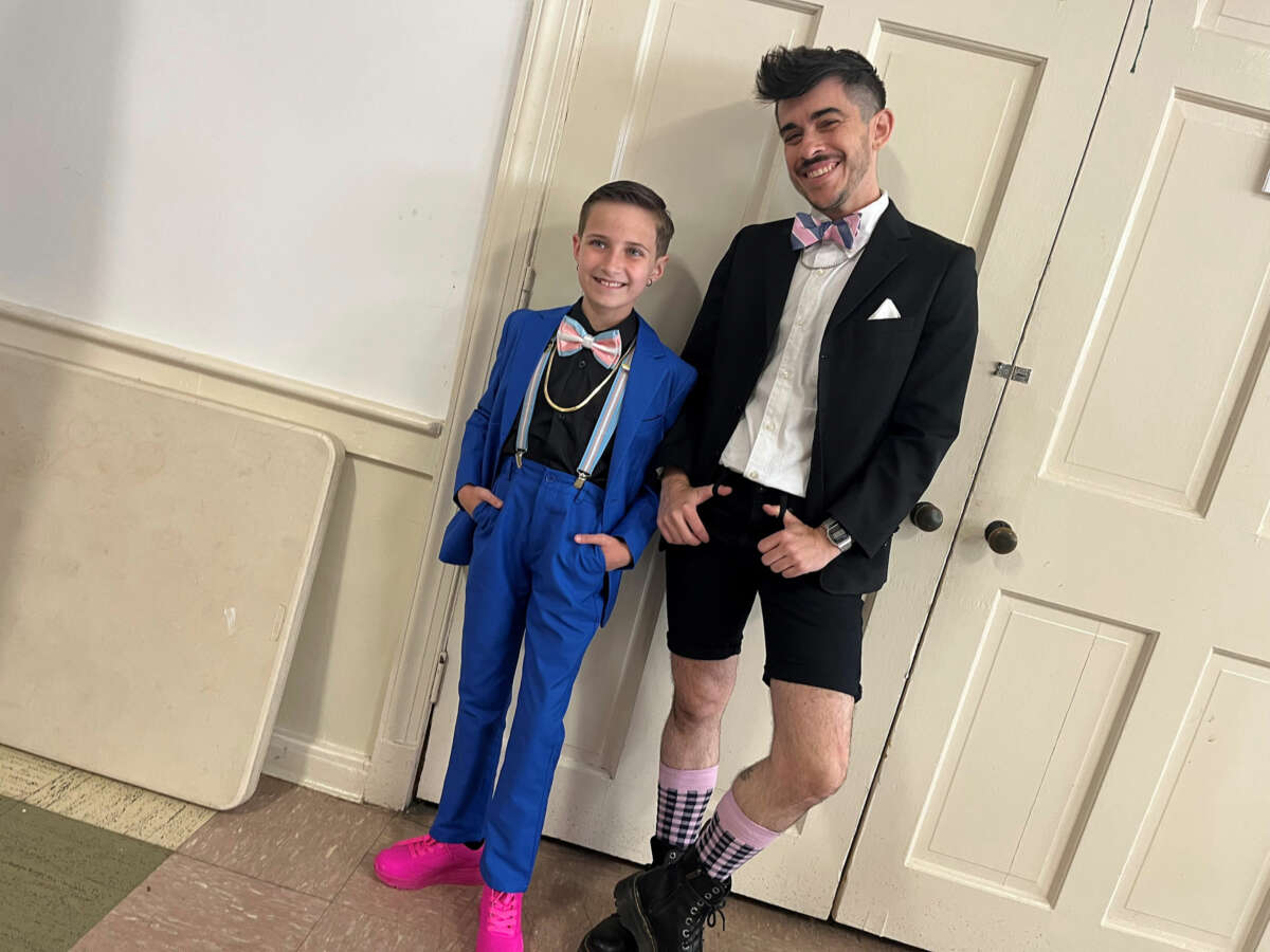 Chase Strangio and a teen take a photo before Trans Prom.