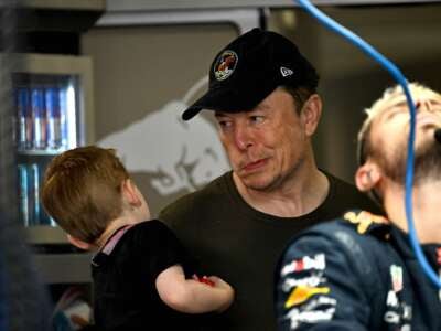 Elon Musk arrives at Red Bull Racing's garage before the 2023 Miami Formula One Grand Prix at the Miami International Autodrome in Miami Gardens, Florida, on May 6, 2023.