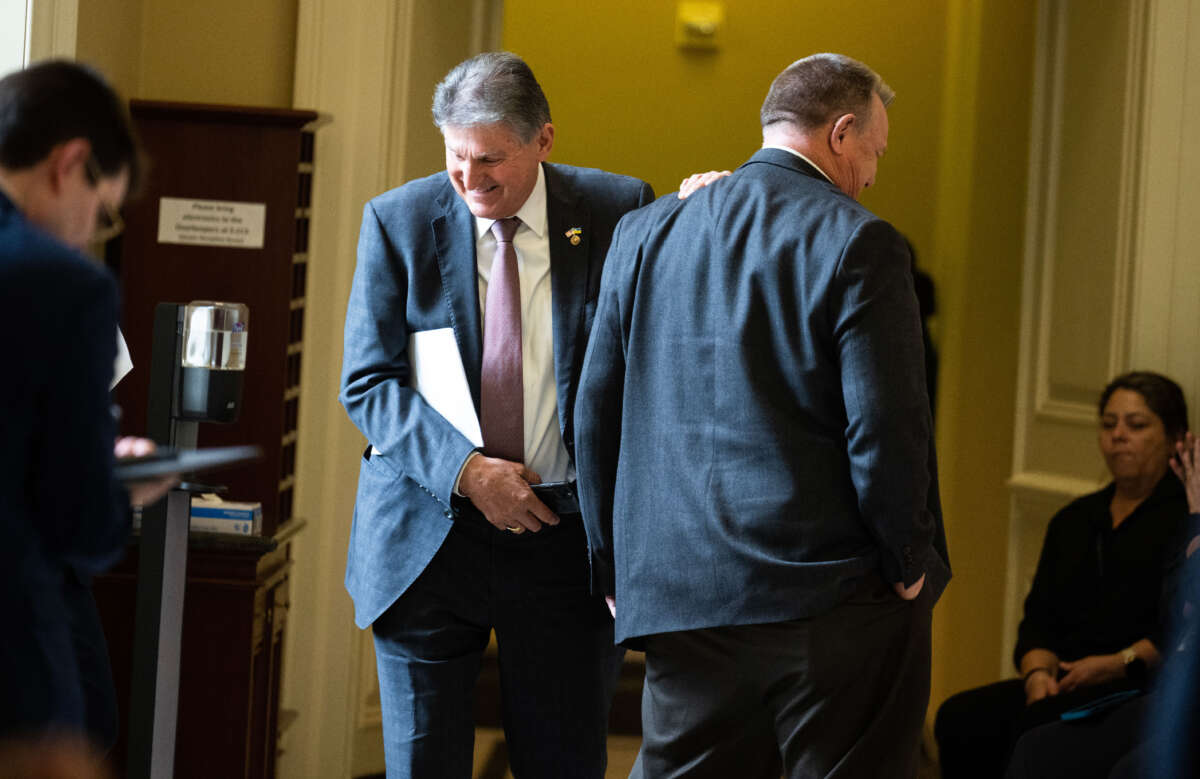 Sen. Joe Manchin (left) and Sen. Jon Tester are seen outside the senate luncheons in the U.S. Capitol on May 2, 2023, in Washington, D.C.