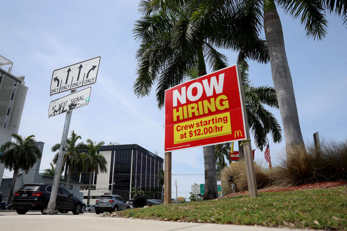 A 'Now Hiring' sign posted outside of a restaurant looking to hire workers on May 5, 2023, in Miami, Florida.