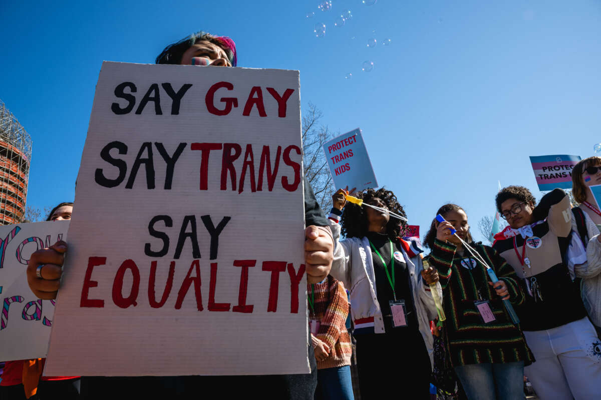 A person with a sign attends a rally to protest the passing of SB 150 on March 29, 2023, at the Kentucky State Capitol in Frankfort, Kentucky.