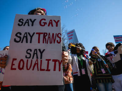 A person with a sign attends a rally to protest the passing of SB 150 on March 29, 2023, at the Kentucky State Capitol in Frankfort, Kentucky.