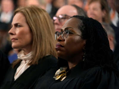 Justice Ketanji Brown Jackson listens to someone speak