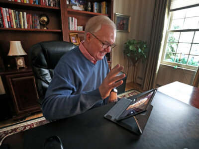 Cigna New England CEO Mark Butler gestures at a tablet computer