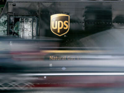 Vehicles are blurred as they drive past a parked UPS delivery vehicle on February 1, 2022, in Los Angeles, California.