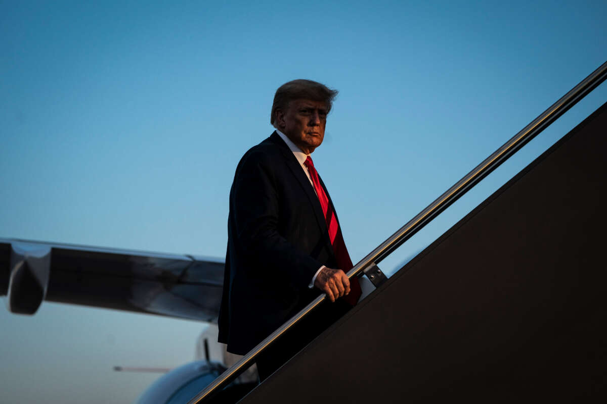 Former President Donald Trump boards his airplane after speaking at a campaign event, at the Manchester-Boston Regional Airport on April 27, 2023, in Manchester, New Hampshire.