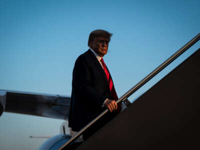 Former President Donald Trump boards his airplane after speaking at a campaign event, at the Manchester-Boston Regional Airport on April 27, 2023, in Manchester, New Hampshire.