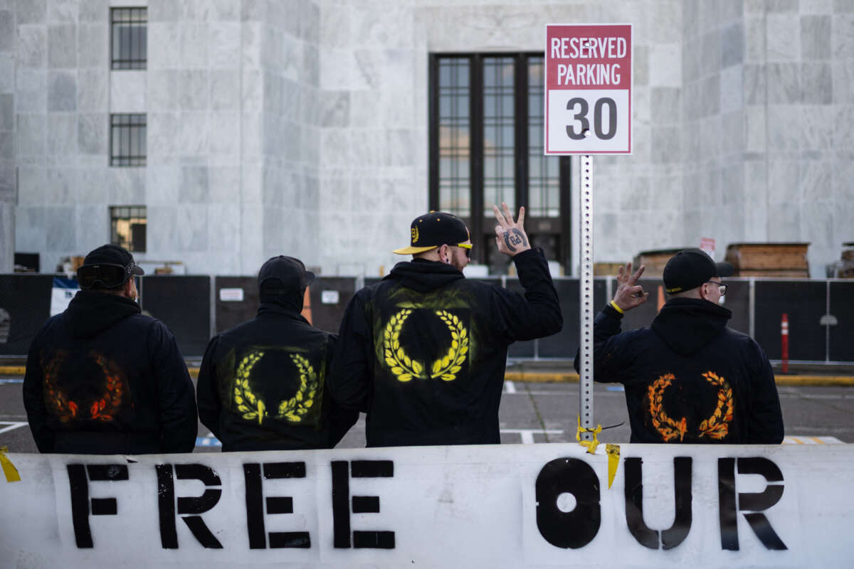 Members of the Proud Boys pose for a picture in front of the Oregon State Capitol building during a far-right rally on January 8, 2022 in Salem, Oregon.