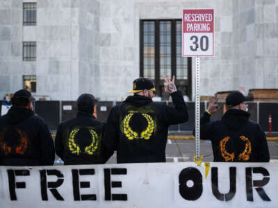 Members of the Proud Boys pose for a picture in front of the Oregon State Capitol building during a far-right rally on January 8, 2022 in Salem, Oregon.