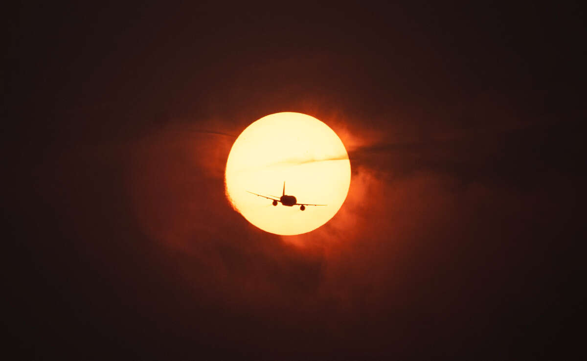 A plane passes in front of the sun as smoke from wildfires in Canada causes hazy conditions in Washington, D.C., on June 7, 2023.