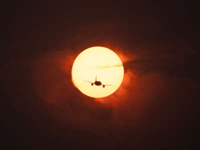 A plane passes in front of the sun as smoke from wildfires in Canada causes hazy conditions in Washington, D.C., on June 7, 2023.