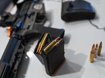 An AR-15 style weapon, a magazine with bullets and different style of bullets are displayed on a table on September 23, 2022, in Aurora, Colorado.