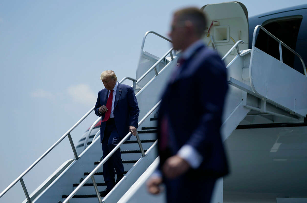 Donald Trump disembarks from a plane