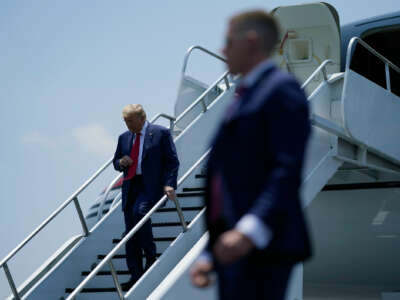 Donald Trump disembarks from a plane