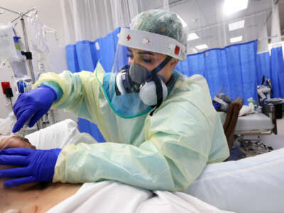 A nurse intubates a patient