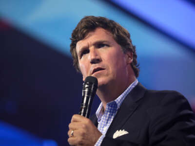 Tucker Carlson speaks with attendees at the 2022 AmericaFest at the Phoenix Convention Center in Phoenix, Arizona.