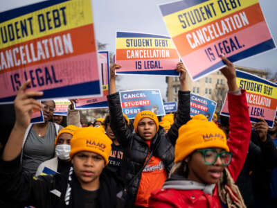 People rally to show support for the Biden administration's student debt relief plan in front of the Supreme Court on February 28, 2023, in Washington, D.C.