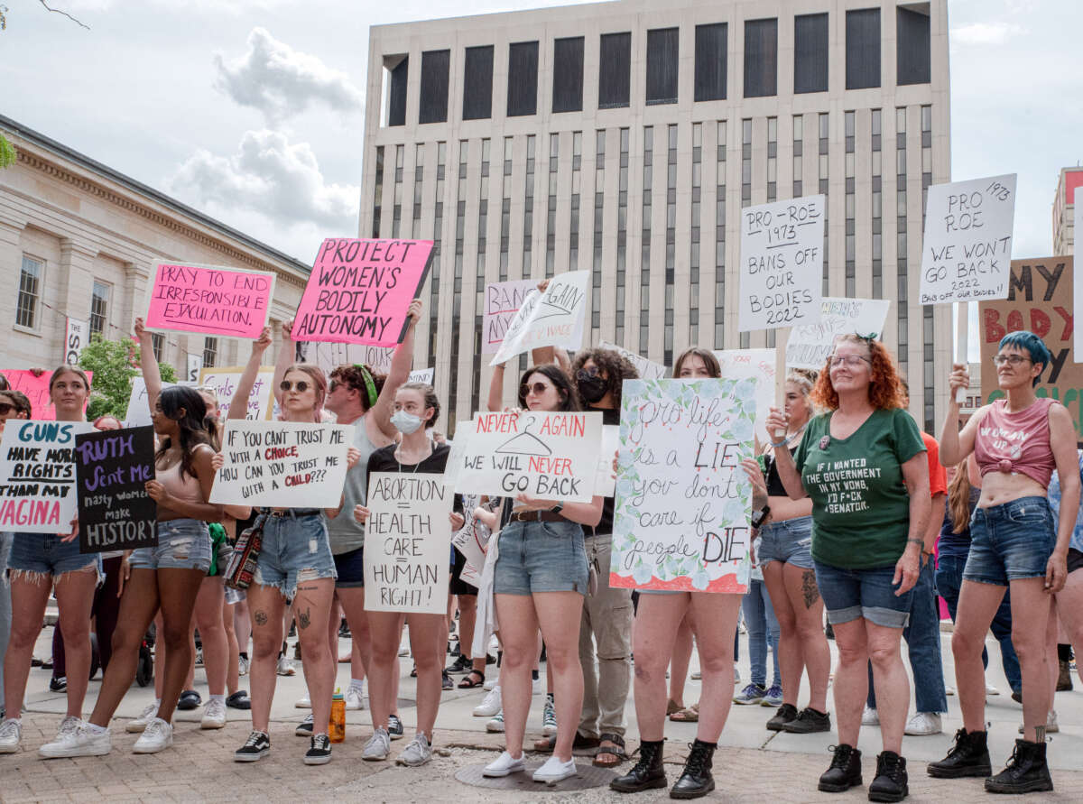 Protesters hold placards at a pro-abortion rights rally in Dayton, Ohio, on May 14, 2022.