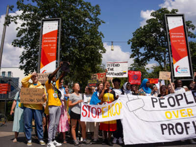 Swedish climate activist Greta Thunberg (left) takes part in a demonstration of the Fridays for Future movement to demand the stop of further funding of new fossil projects, in front of the headquarters of German retail banking company Postbank in Bonn, Germany, on June 12, 2023.