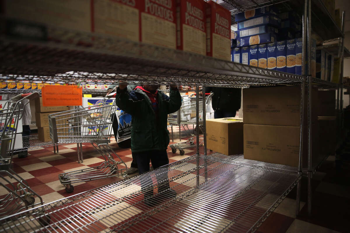 A child accompanies his grandmother choosing groceries at a food pantry run by the Food Bank For New York City on December 11, 2013, in New York City.