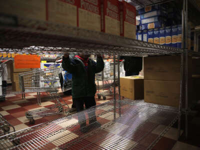 A child accompanies his grandmother choosing groceries at a food pantry run by the Food Bank For New York City on December 11, 2013, in New York City.
