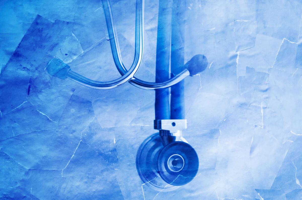 Stethoscope in blue on torn paper