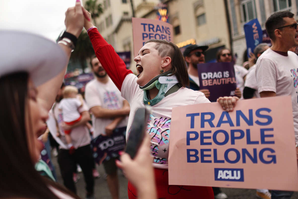 ACLU march participants chant and hold signs in support of rights for transgender people and drag performers during the 2023 LA Pride Parade in Hollywood on June 11, 2023, in Los Angeles, California.