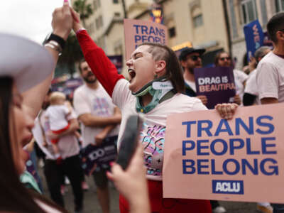 ACLU march participants chant and hold signs in support of rights for transgender people and drag performers during the 2023 LA Pride Parade in Hollywood on June 11, 2023, in Los Angeles, California.