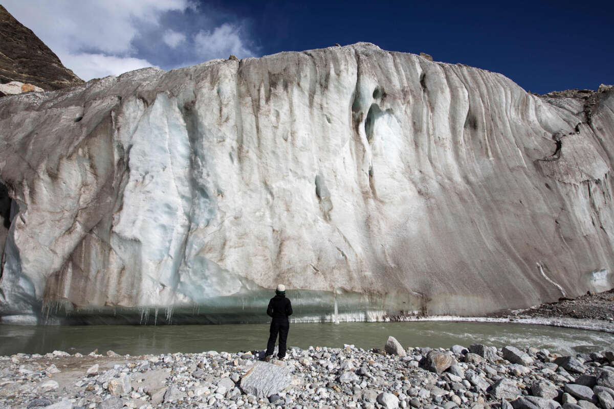 his picture taken on October 19, 2022, shows a trekker observing the Gangotri Glacier, which is one source of the Ganges River, at Gangotri National Park.