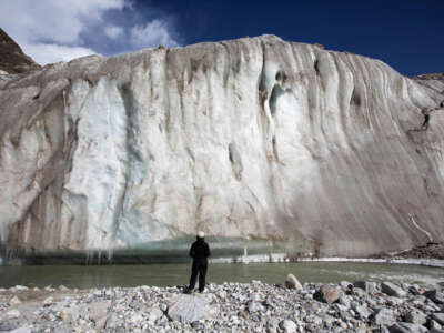 his picture taken on October 19, 2022, shows a trekker observing the Gangotri Glacier, which is one source of the Ganges River, at Gangotri National Park.