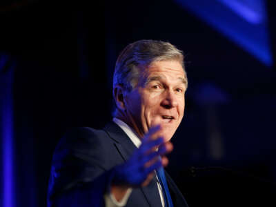 Gov. Roy Cooper addresses the crowd during the North Carolina Democratic Party's election night party at The Dock at Seabord Station in Raleigh, North Carolina, on May 17, 2022.