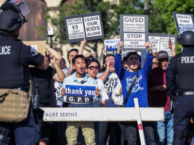 Anti-LGBTQIA+ protesters display signs and chant