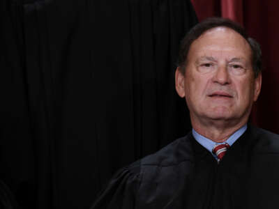 Justice Samuel Alito attempts to smile during a staff portrait