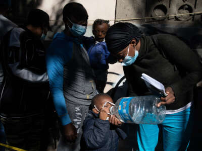 Migrants, mostly from Haiti, line up to apply for humanitarian asylum, in front of the Mexican Commission for Refugee Assistance, in Mexico City, Mexico, on May 16, 2023.