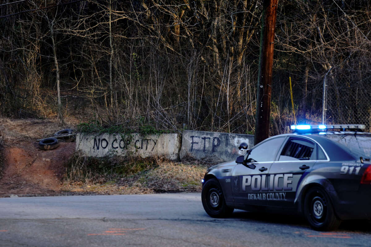 Law enforcement drive past the planned site of a police training facility that activists have nicknamed Cop City, following the first raid since the death of environmental activist Manuel Teran near Atlanta, Georgia, on February 6, 2023.