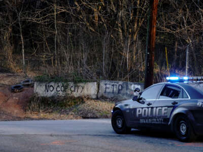 Law enforcement drive past the planned site of a police training facility that activists have nicknamed Cop City, following the first raid since the death of environmental activist Manuel Teran near Atlanta, Georgia, on February 6, 2023.