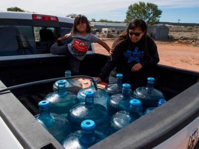 Members of the Larson family, who have no running water in their home, collect water from a distribution point in the Navajo Nation town of Thoreau in New Mexico on May 22, 2020.