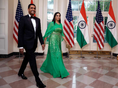 Ro Khanna enters an event holding his wife's hand