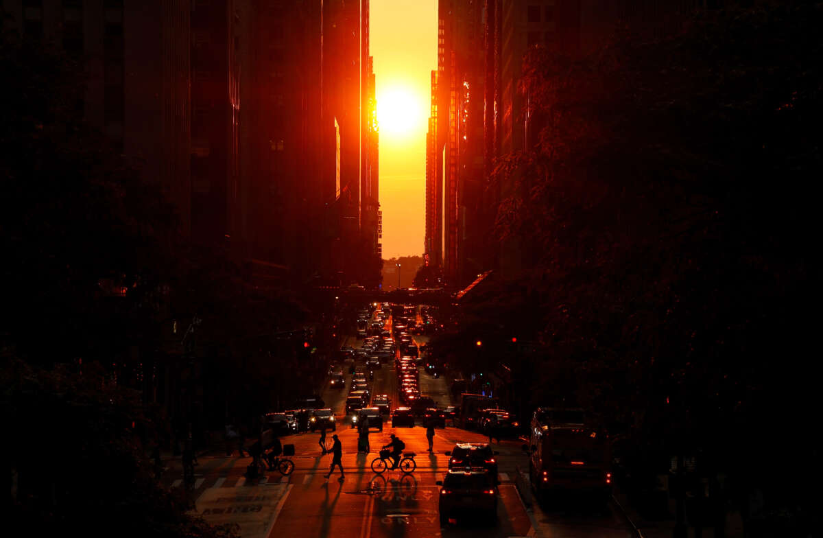 The sun sets along 42nd Street as light smoke from wildfires in Canada begins to drift into the northeast on June 15, 2023, in New York City.