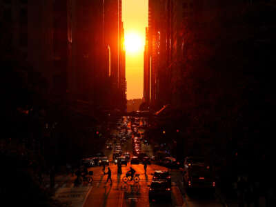 The sun sets along 42nd Street as light smoke from wildfires in Canada begins to drift into the northeast on June 15, 2023, in New York City.