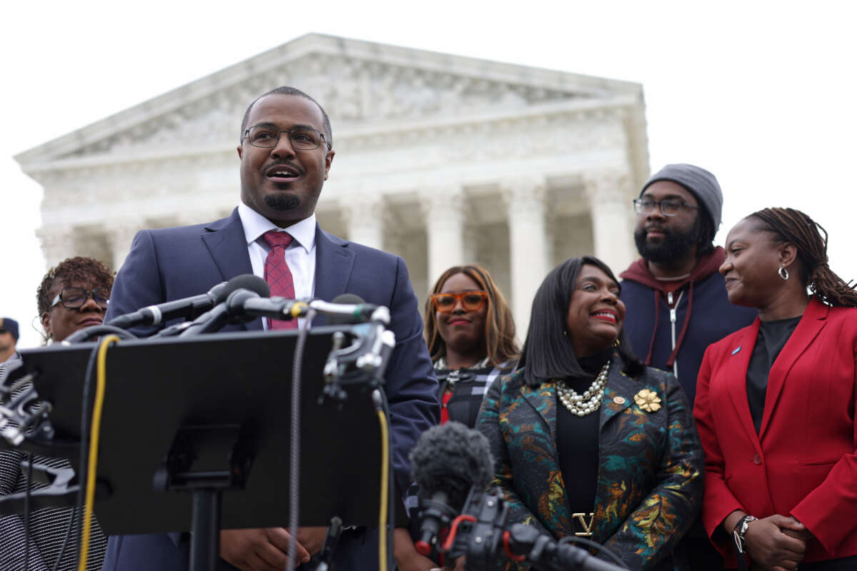 Lead counsel for the plaintiffs Deuel Ross (2nd left) speaks to members of the press as President and Director-Counsel of the NAACP Legal Defense Fund Janai Nelson (right), plaintiff Evan Milligan (2nd right) and Rep. Terri Sewell (3rd right) listen after the oral argument of the Merrill v. Milligan case at the U.S. Supreme Court on October 4, 2022, in Washington, D.C.