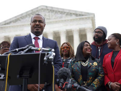 Lead counsel for the plaintiffs Deuel Ross (2nd left) speaks to members of the press as President and Director-Counsel of the NAACP Legal Defense Fund Janai Nelson (right), plaintiff Evan Milligan (2nd right) and Rep. Terri Sewell (3rd right) listen after the oral argument of the Merrill v. Milligan case at the U.S. Supreme Court on October 4, 2022, in Washington, D.C.