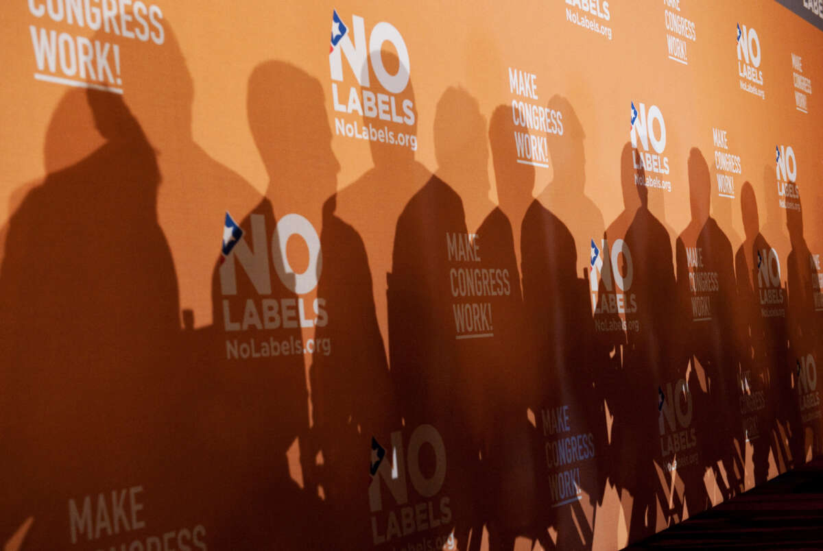 The shadows of several Democratic and Republican politicians are cast on a background during an event in Cannon Building hosted by No Labels to announce a congressional action plan on December 13, 2011.